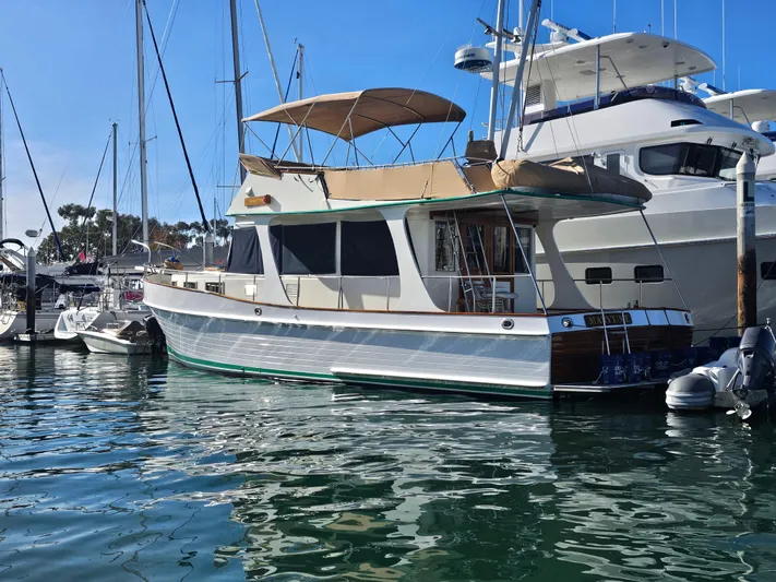 Marytime Yacht Photos Pics 1987 Grand Banks 42 Europa yacht docked in a marina, featuring classic design and spacious deck.