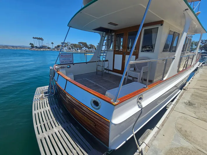 Marytime Yacht Photos Pics 1987 Grand Banks 42 Europa yacht docked at marina, featuring wooden accents and spacious deck.