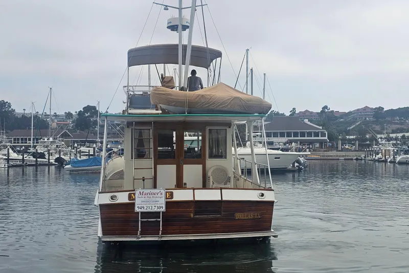 Marytime Yacht Photos Pics 1987 Grand Banks 42 Europa yacht docked in a marina, rear view.