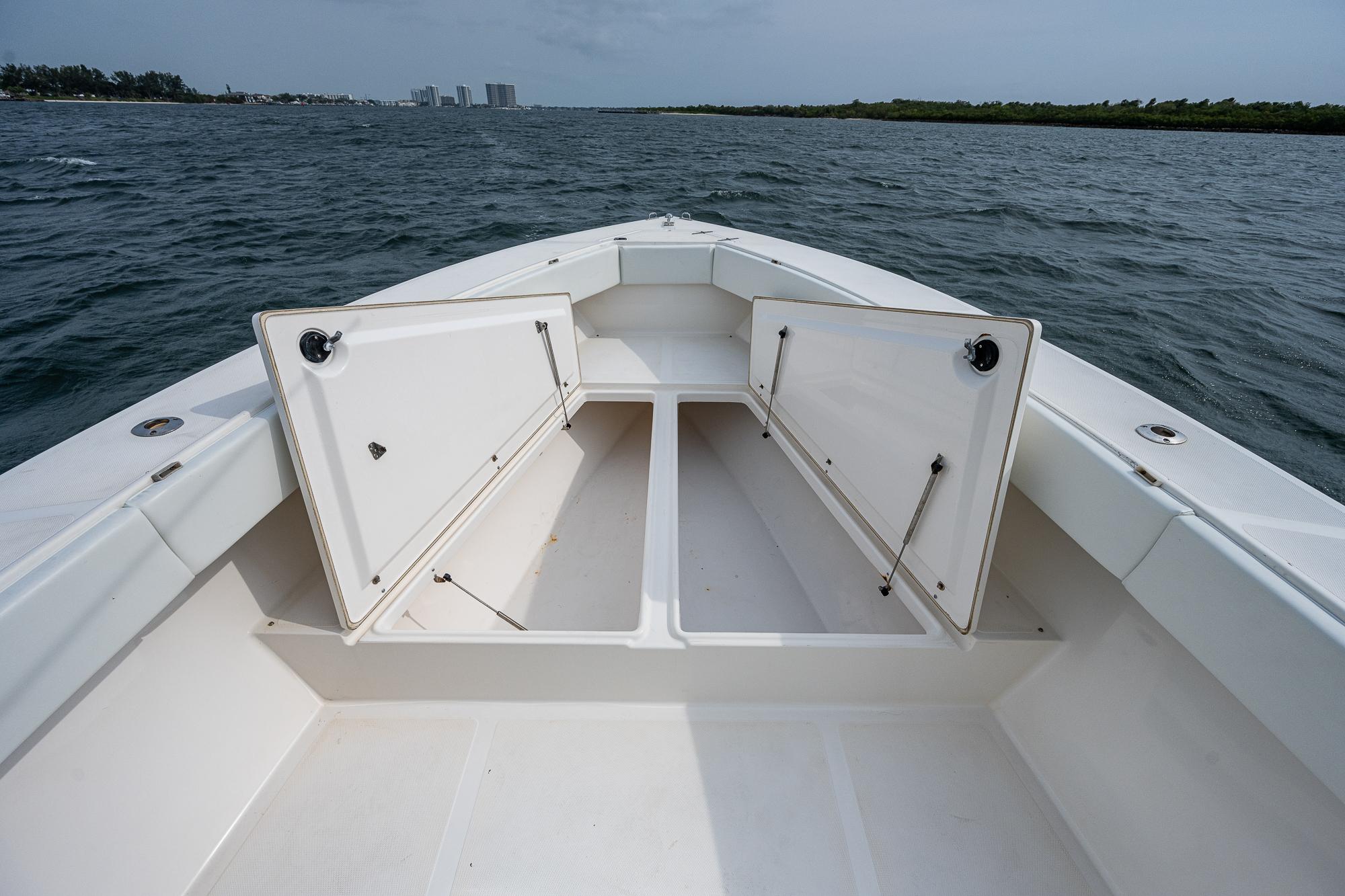 Venture 34 Open CC 1999 boat with open storage on the water.