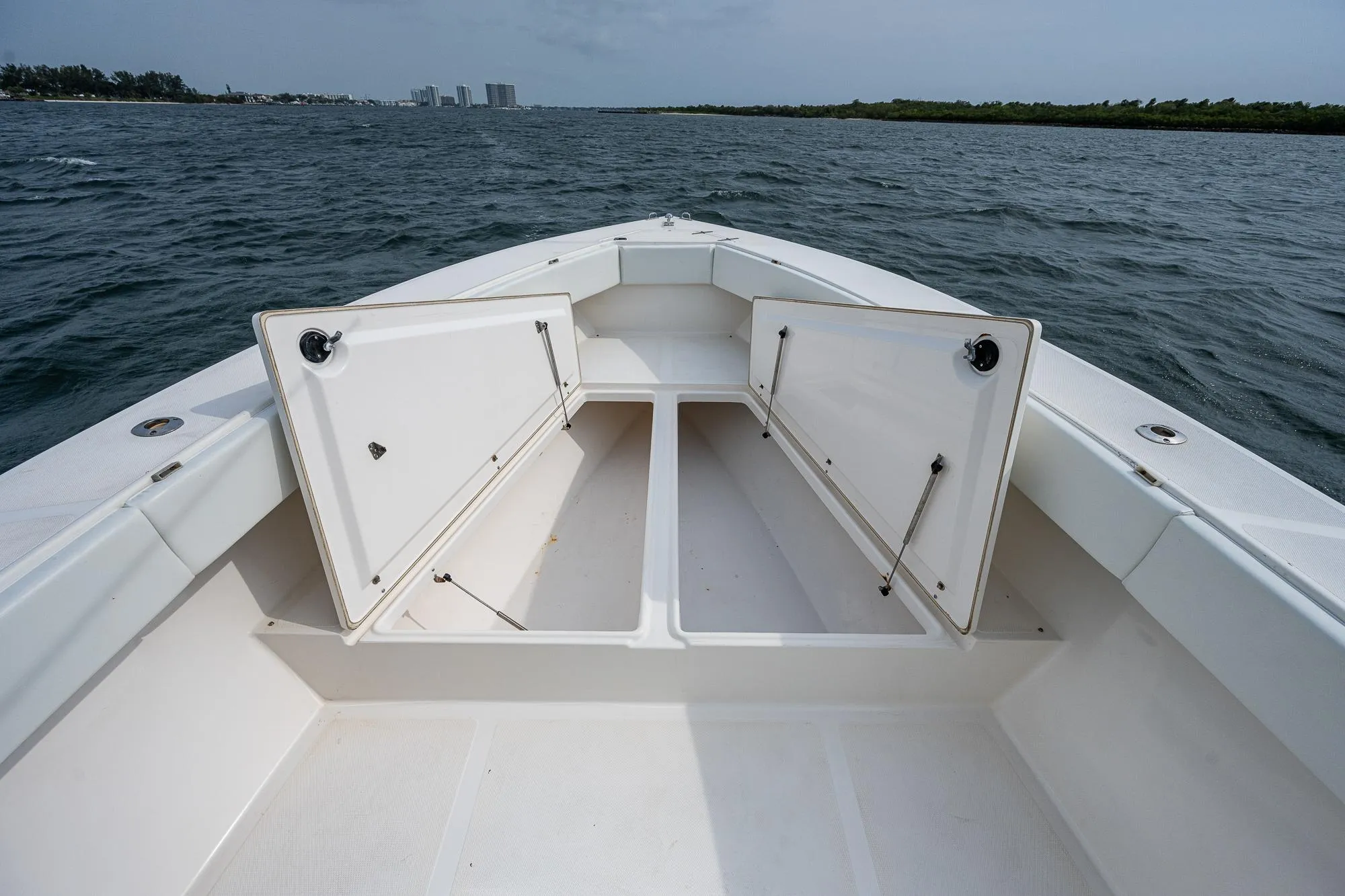 Venture 34 Open CC 1999 boat with open storage on the water.