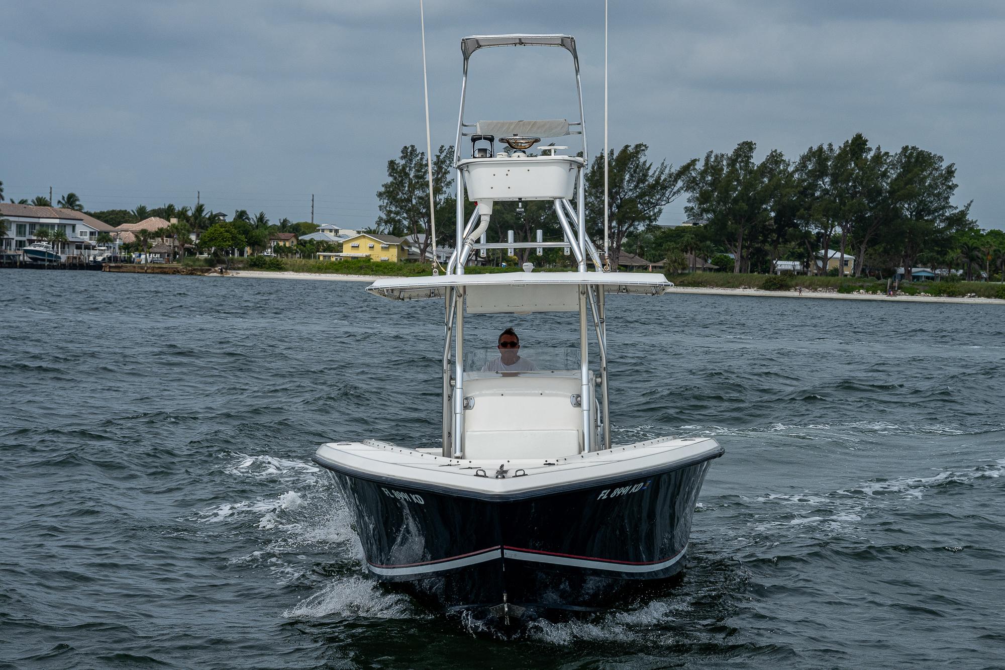 1999 Venture 34 Open CC boat cruising on water.