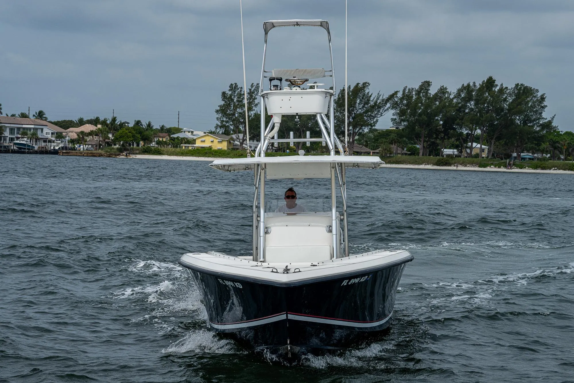 1999 Venture 34 Open CC boat cruising on water.