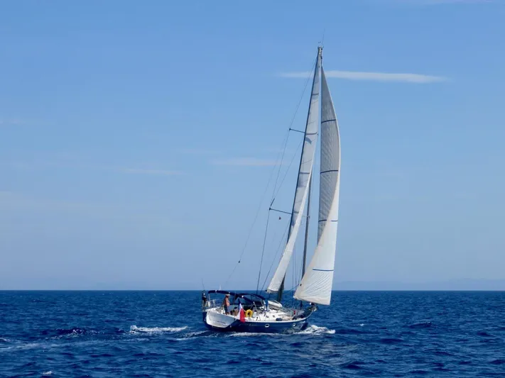  Yacht Photos Pics Jeanneau Sun Odyssey 45.2 sailing on open sea, 2000 model.