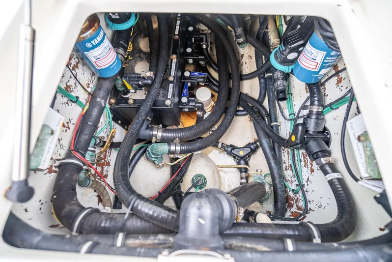  Yacht Photos Pics Engine compartment of a 2014 SeaVee 34 boat, featuring Yamaha components and various hoses.