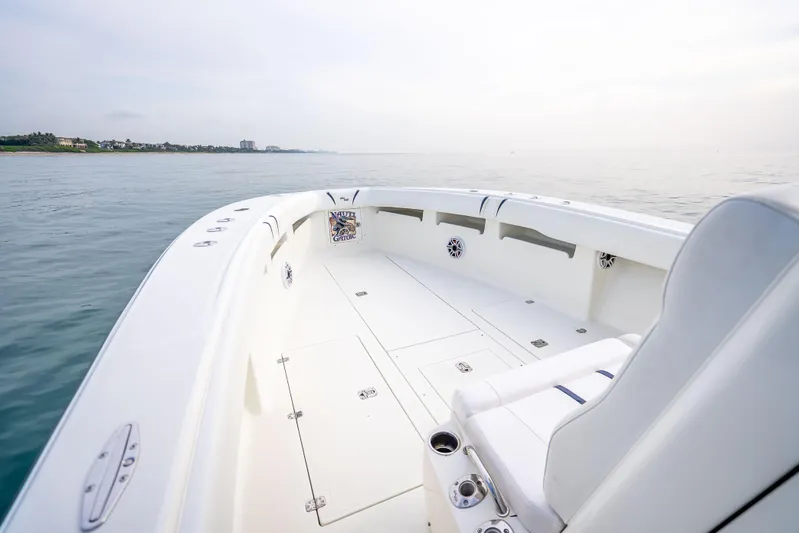  Yacht Photos Pics 2014 SeaVee 34 boat on calm water, featuring spacious deck and seating.