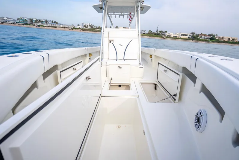  Yacht Photos Pics 2014 SeaVee 34 boat interior with open storage compartments, on calm blue water.