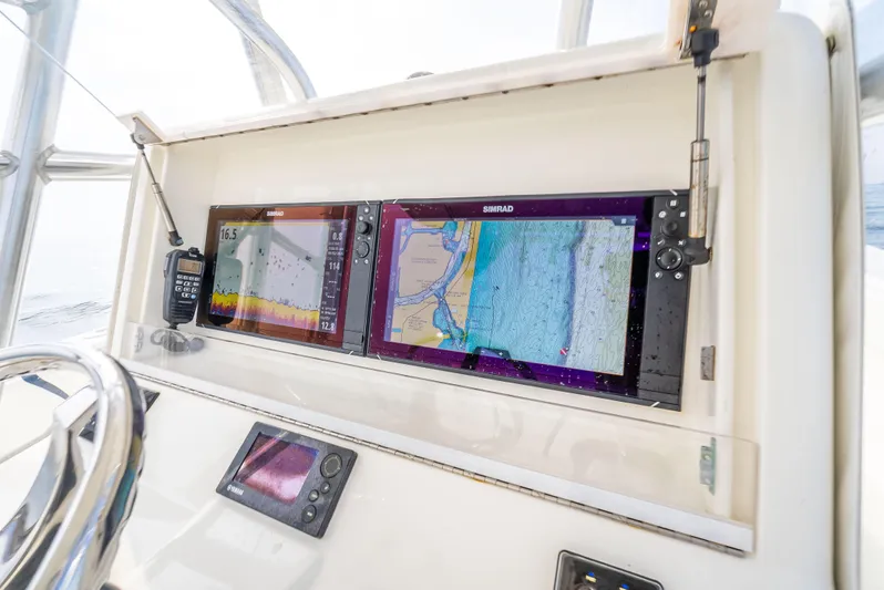  Yacht Photos Pics 2014 SeaVee 34 boat dashboard with dual navigation screens and controls.