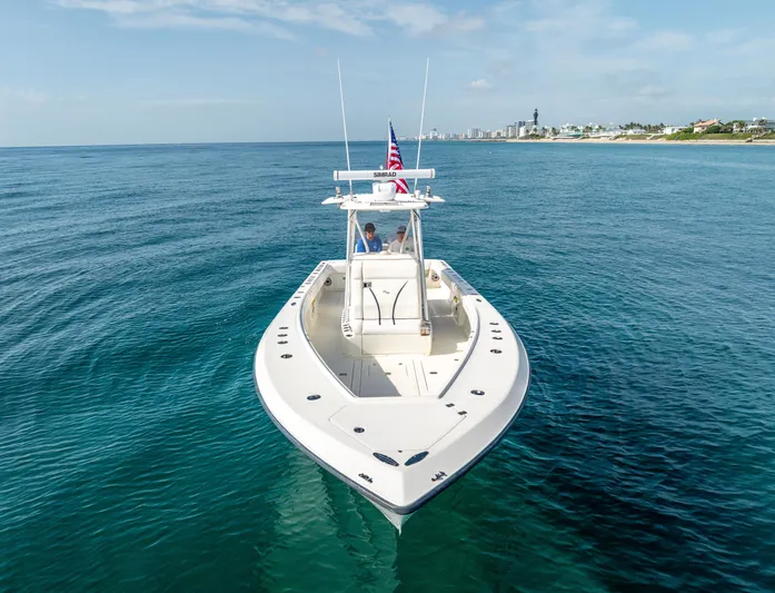  Yacht Photos Pics 2014 SeaVee 34 boat on calm ocean, clear sky, distant shoreline.
