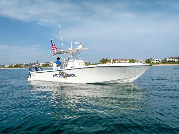  Yacht Photos Pics 2014 SeaVee 34 boat on water, American flag, clear sky, coastal background.