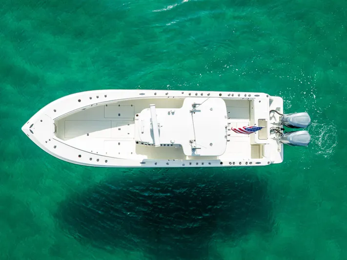  Yacht Photos Pics Aerial view of 2014 SeaVee 34 boat on clear turquoise water.
