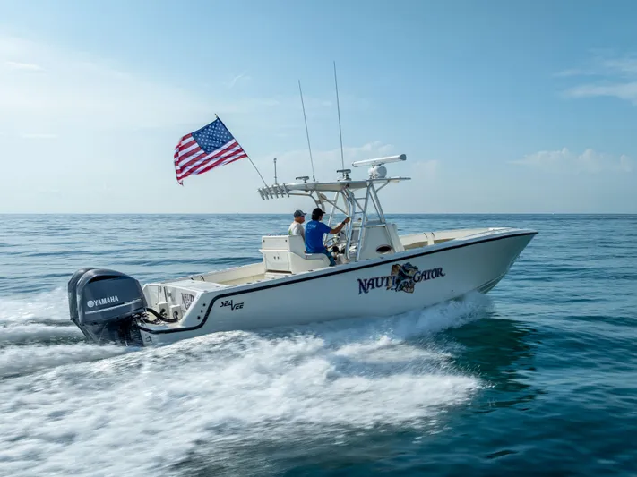  Yacht Photos Pics 2014 SeaVee 34 boat cruising on ocean with American flag and Yamaha engine.