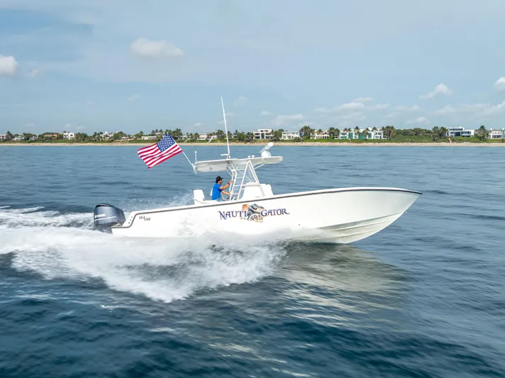  Yacht Photos Pics 2014 SeaVee 34 boat cruising on open water with American flag.