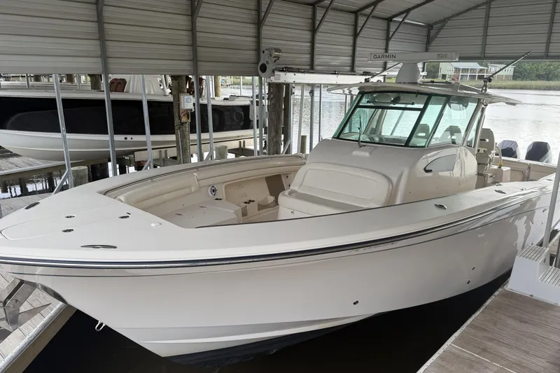  Yacht Photos Pics 2015 Grady-White Canyon 376 boat docked under a covered marina.