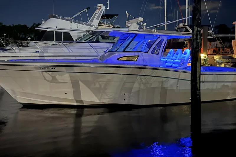  Yacht Photos Pics 2015 Grady-White Canyon 376 boat illuminated at night in a marina.