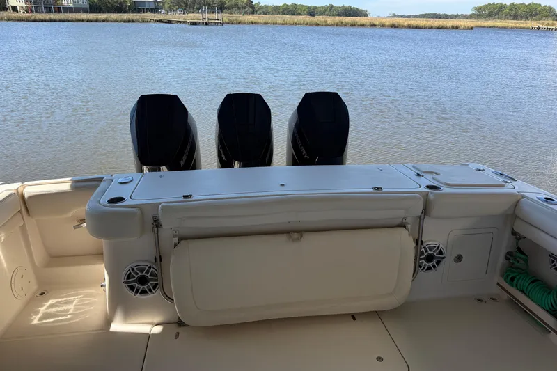  Yacht Photos Pics 2015 Grady-White Canyon 376 boat with triple outboard motors on a calm lake.
