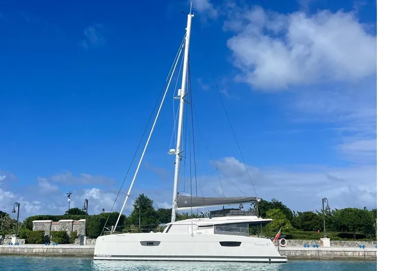 Portlish Yacht Photos Pics 2022 Fountaine Pajot Tanna 47 catamaran docked under clear blue sky.