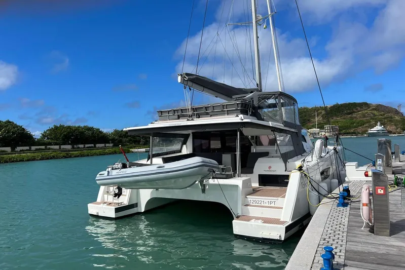 Portlish Yacht Photos Pics 2022 Fountaine Pajot Tanna 47 catamaran docked in a scenic marina.