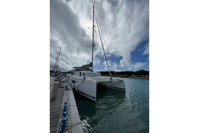 Portlish Yacht Photos Pics 2022 Fountaine Pajot Tanna 47 catamaran docked under cloudy sky.