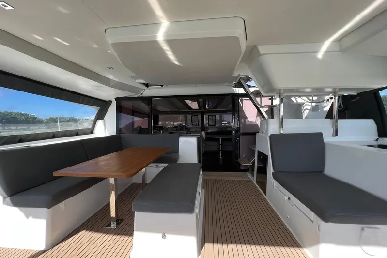 Portlish Yacht Photos Pics Luxurious interior of 2022 Fountaine Pajot Tanna 47 catamaran with spacious seating and dining area.