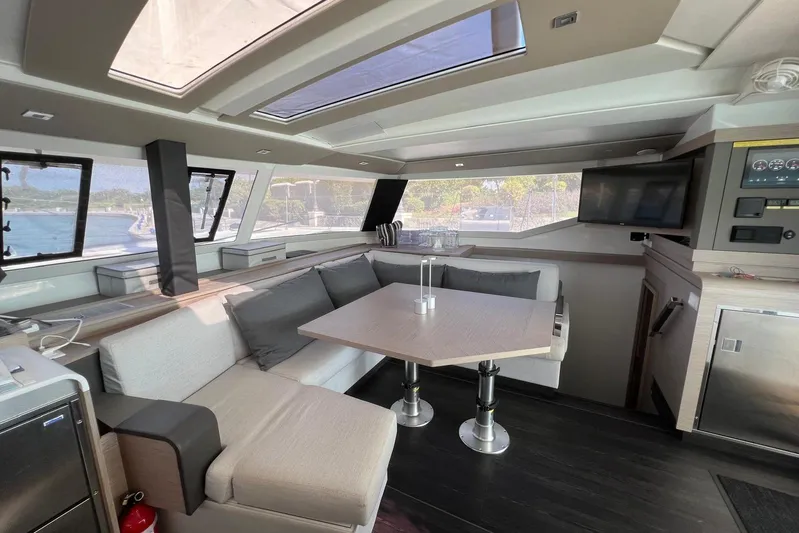 Portlish Yacht Photos Pics Luxurious interior of 2022 Fountaine Pajot Tanna 47 catamaran with modern seating and panoramic windows.