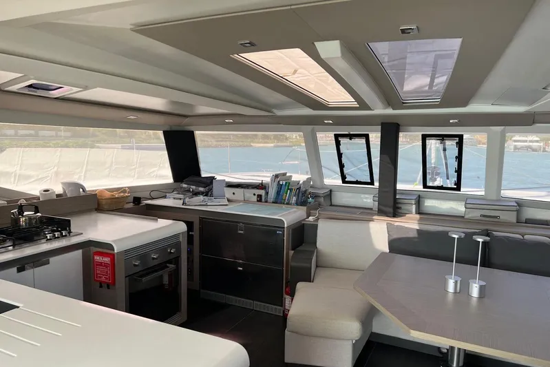 Portlish Yacht Photos Pics Modern interior of 2022 Fountaine Pajot Tanna 47 catamaran with kitchen and dining area.