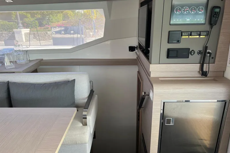 Portlish Yacht Photos Pics Interior of 2022 Fountaine Pajot Tanna 47 yacht, featuring modern seating and control panel.