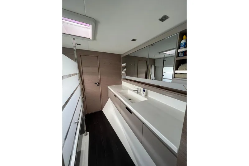 Portlish Yacht Photos Pics Modern bathroom interior of 2022 Fountaine Pajot Tanna 47 yacht, featuring sleek design and ample storage.