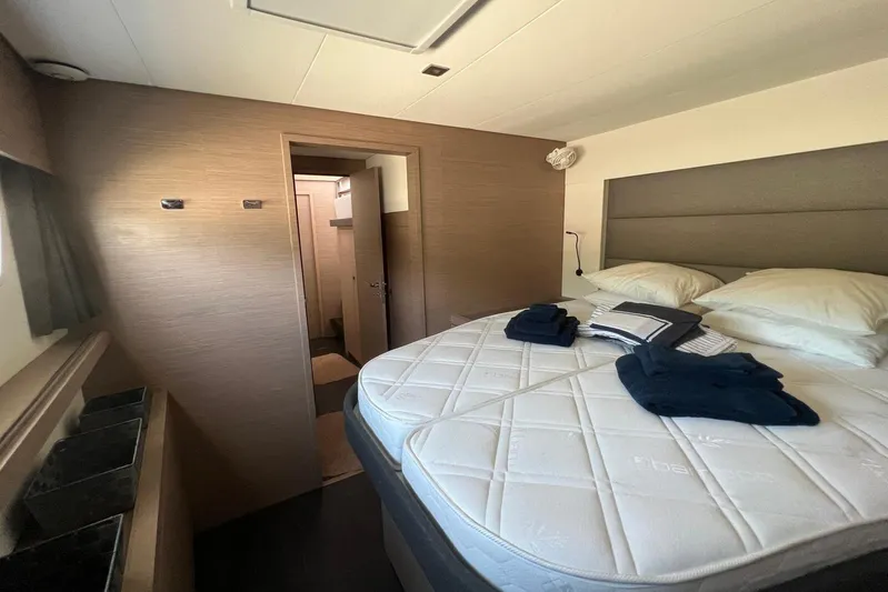 Portlish Yacht Photos Pics Luxurious cabin interior of 2022 Fountaine Pajot Tanna 47 yacht with cozy bedding.
