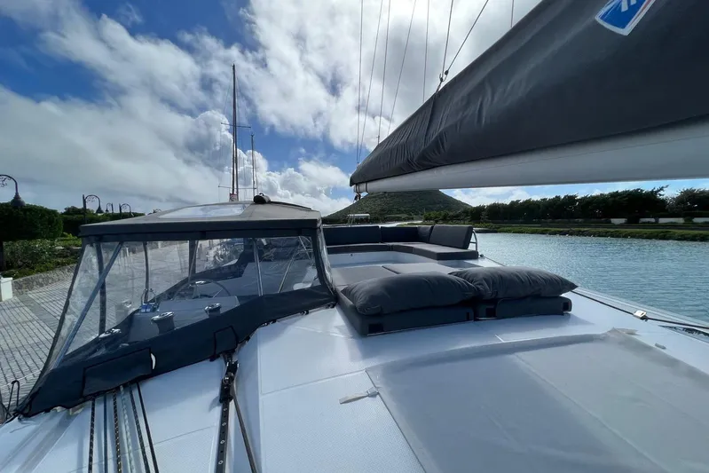 Portlish Yacht Photos Pics 2022 Fountaine Pajot Tanna 47 catamaran with spacious deck and scenic waterway view.