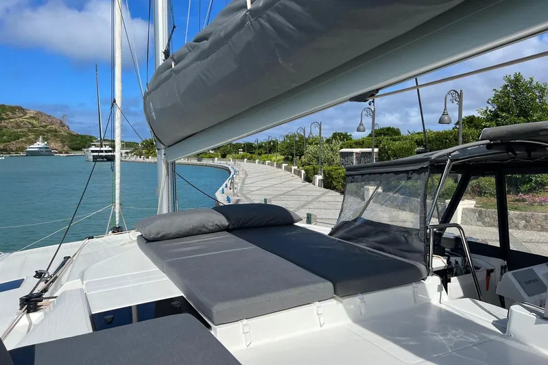 Portlish Yacht Photos Pics 2022 Fountaine Pajot Tanna 47 catamaran docked, featuring spacious deck and scenic waterfront view.