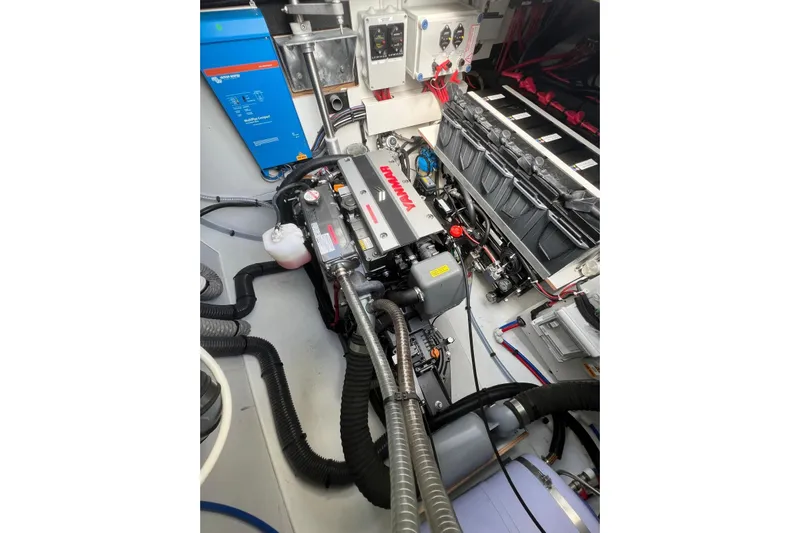Portlish Yacht Photos Pics Engine room of 2022 Fountaine Pajot Tanna 47 catamaran, showcasing mechanical components and wiring.