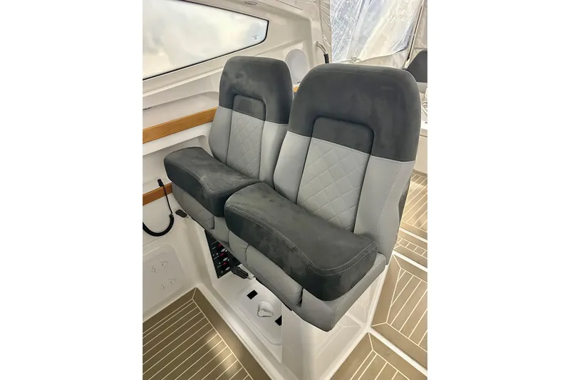 Delphin Yacht Photos Pics 2023 Nimbus Weekender 9 interior with dual gray and black cushioned seats.