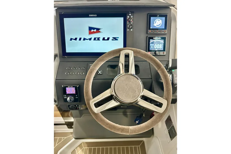 Delphin Yacht Photos Pics 2023 Nimbus Weekender 9 helm with modern steering wheel and digital displays.