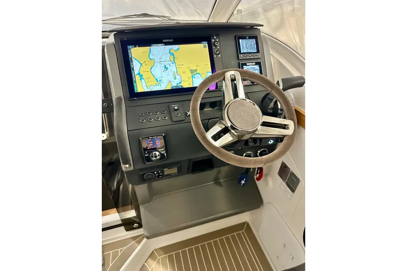 Delphin Yacht Photos Pics 2023 Nimbus Weekender 9 dashboard with navigation display and steering wheel.