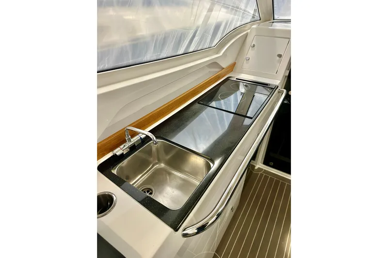 Delphin Yacht Photos Pics 2023 Nimbus Weekender 9 boat kitchen with sleek sink and stove setup.