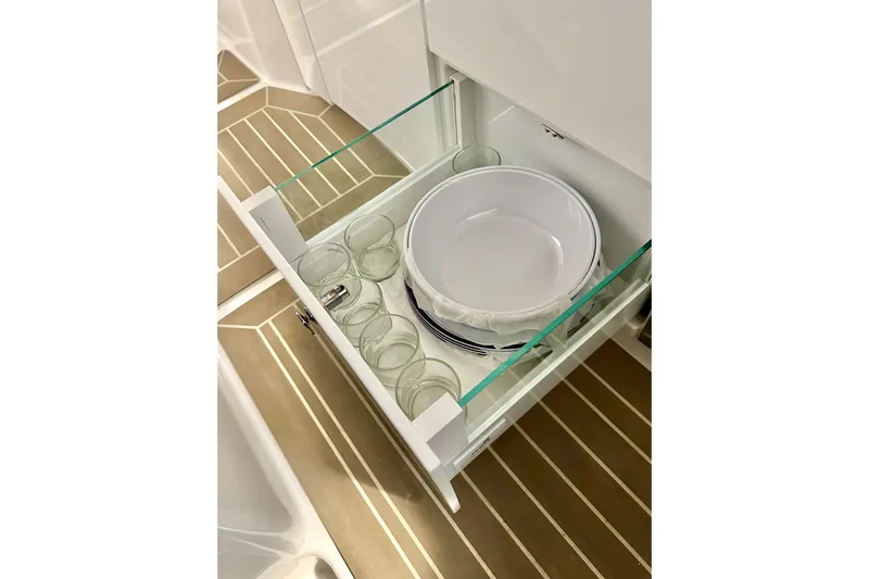 Delphin Yacht Photos Pics Open drawer with dishes and glasses on Nimbus Weekender 9, 2023 model.
