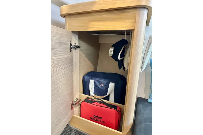 Delphin Yacht Photos Pics Storage cabinet in 2023 Nimbus Weekender 9 with emergency kit and bags.