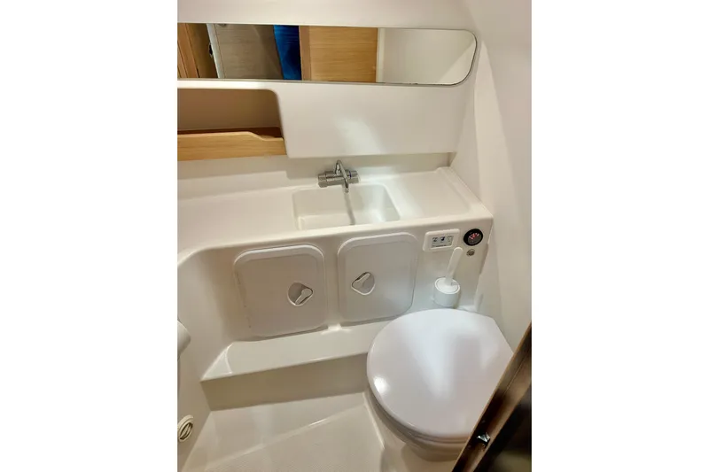 Delphin Yacht Photos Pics 2023 Nimbus Weekender 9 boat bathroom with sink, mirror, and toilet.