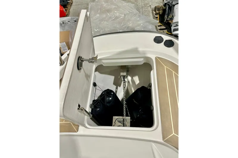 Delphin Yacht Photos Pics Open storage compartment on 2023 Nimbus Weekender 9 boat, showing anchor and chain.