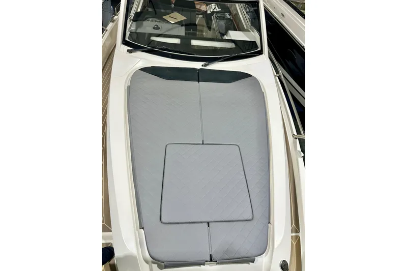 Delphin Yacht Photos Pics 2023 Nimbus Weekender 9 boat with gray cushioned deck, sleek design.