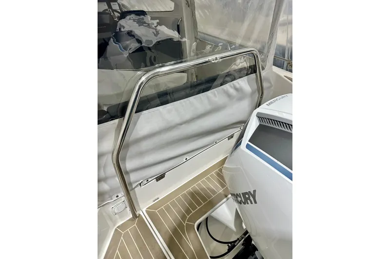 Delphin Yacht Photos Pics 2023 Nimbus Weekender 9 boat interior with Mercury engine and stainless steel railing.