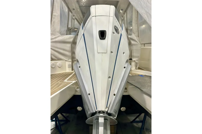 Delphin Yacht Photos Pics 2023 Nimbus Weekender 9 boat engine, sleek design, white and blue accents.