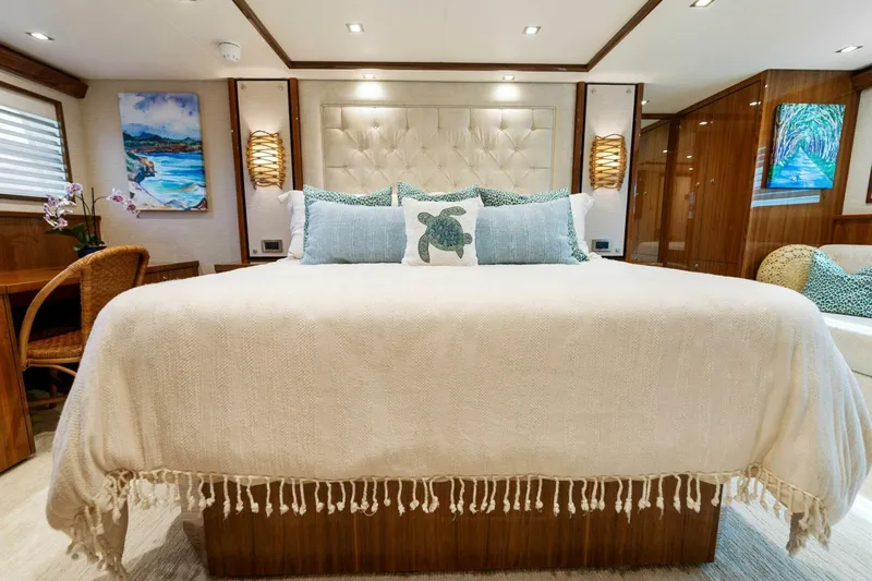 Mana Yacht Photos Pics Luxurious bedroom interior of 2021 Viking 82 Cockpit Motor Yacht with elegant decor.