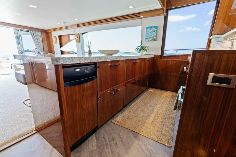 Mana Yacht Photos Pics Luxurious kitchen interior of 2021 Viking 82 Cockpit Motor Yacht with ocean view.