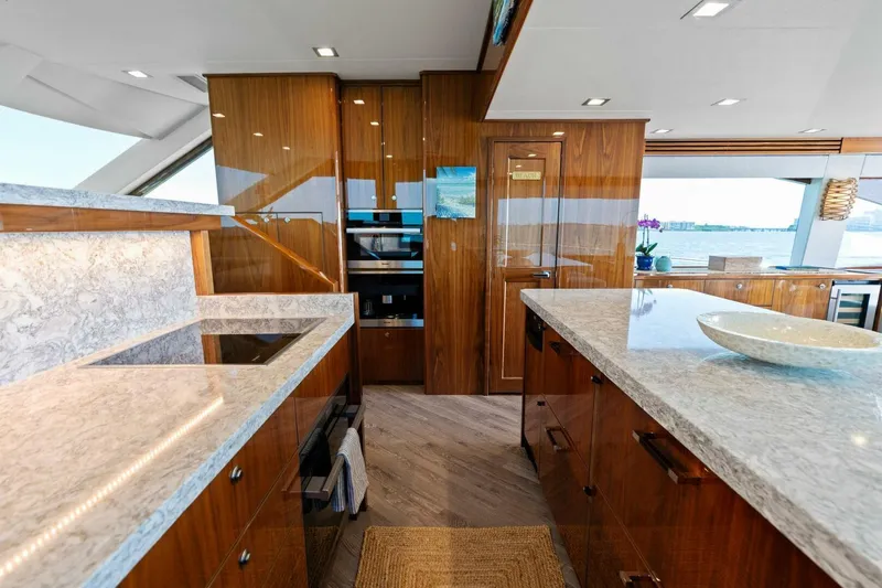 Mana Yacht Photos Pics Luxurious kitchen interior of 2021 Viking 82 Cockpit Motor Yacht with modern design.
