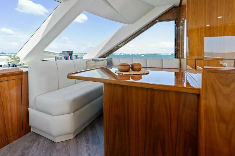 Mana Yacht Photos Pics Luxurious interior of 2021 Viking 82 Cockpit Motor Yacht with elegant wood finishes.