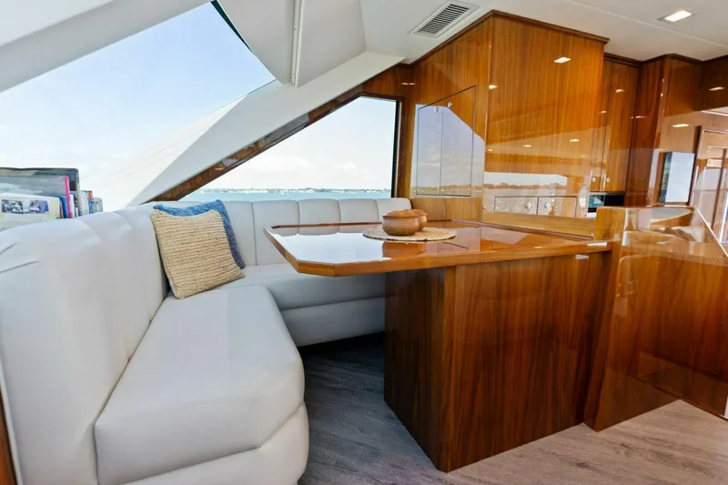 Mana Yacht Photos Pics Luxurious interior of 2021 Viking 82 Cockpit Motor Yacht with elegant wood finishes.