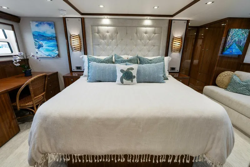 Mana Yacht Photos Pics Luxurious bedroom interior of 2021 Viking 82 Cockpit Motor Yacht with elegant decor.