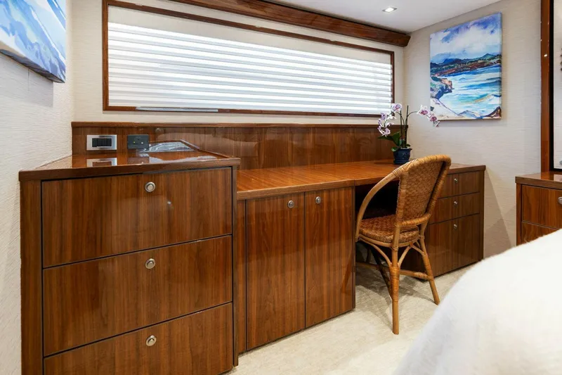 Mana Yacht Photos Pics Luxurious wood interior of 2021 Viking 82 Cockpit Motor Yacht with desk and chair.